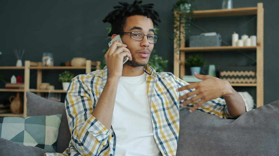 person using smartphone on couch