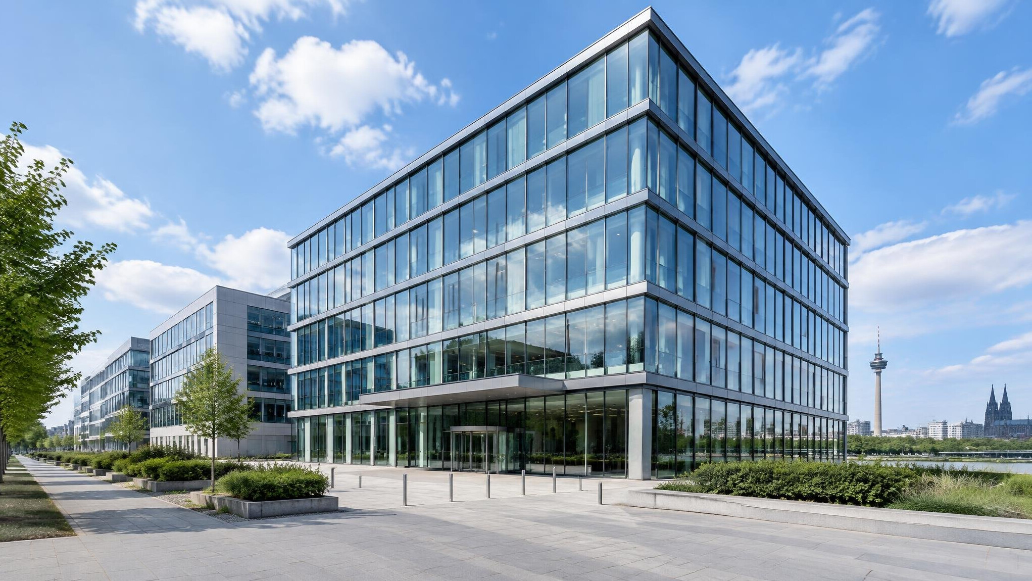 Modern glass office building exterior against a blue sky