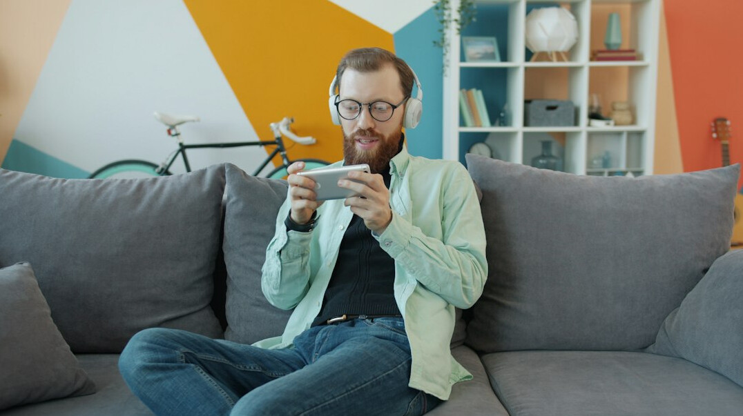 person using smartphone on couch
